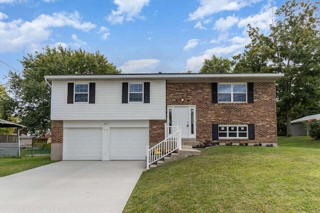 raised ranch featuring a garage and a front yard