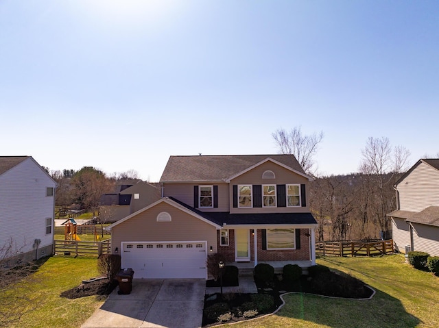 traditional-style house featuring concrete driveway, an attached garage, fence, and a front yard