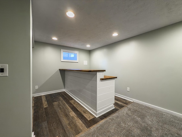 bar with recessed lighting, baseboards, a textured ceiling, and dark wood-style flooring