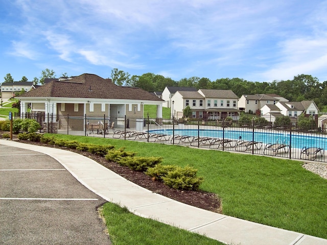 view of swimming pool featuring a patio and a lawn