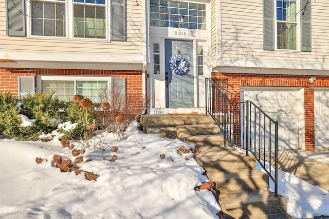 view of snow covered property entrance