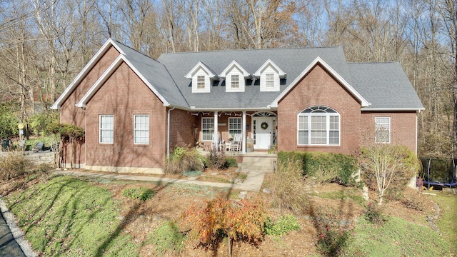 view of front of property with covered porch and a trampoline