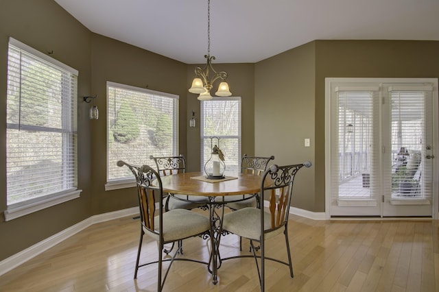 dining area featuring a notable chandelier and light hardwood / wood-style floors