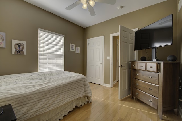 bedroom with ceiling fan and light hardwood / wood-style floors