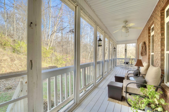 sunroom with ceiling fan and a healthy amount of sunlight