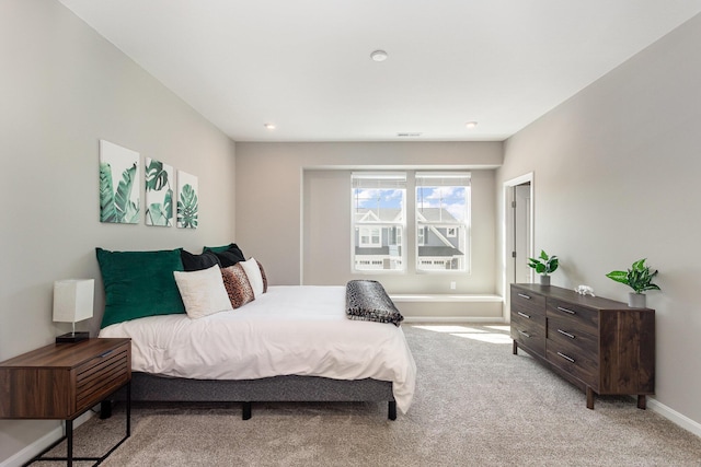 bedroom featuring light carpet