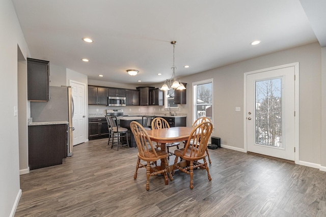 dining area featuring sink and dark hardwood / wood-style flooring