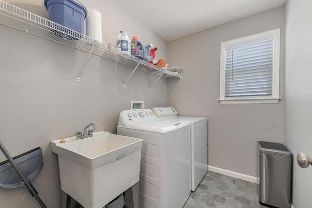 washroom featuring washer and dryer and sink