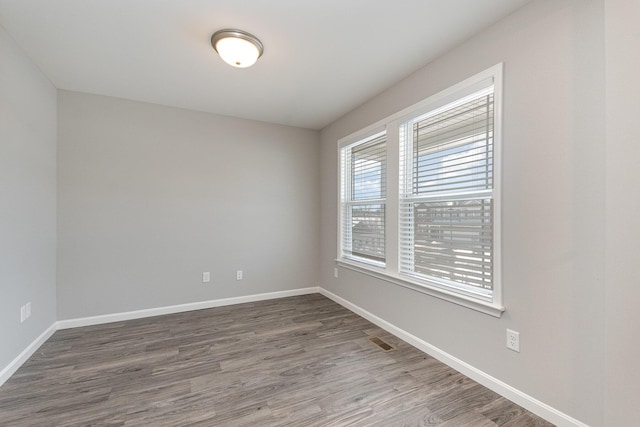 spare room featuring dark hardwood / wood-style flooring