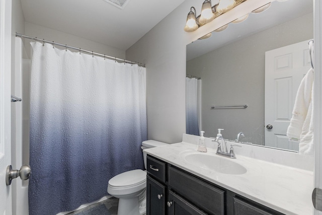 bathroom with toilet and vanity