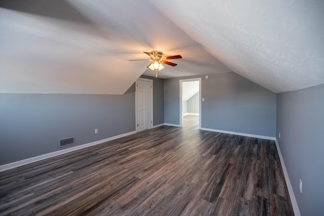 bonus room with vaulted ceiling, dark wood-type flooring, and ceiling fan