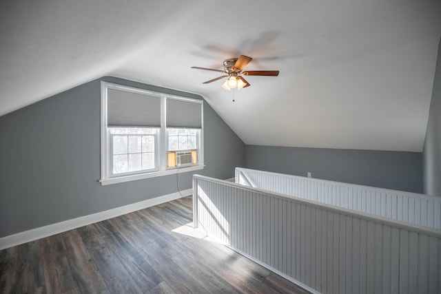 additional living space featuring lofted ceiling, cooling unit, hardwood / wood-style flooring, and ceiling fan