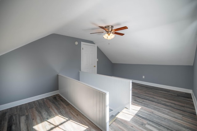 bonus room with vaulted ceiling, ceiling fan, and dark hardwood / wood-style flooring