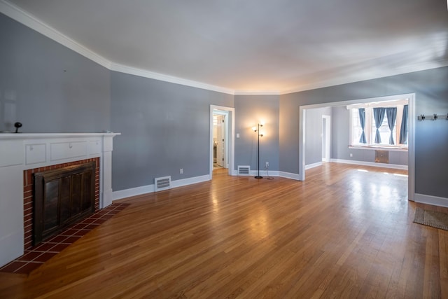 unfurnished living room with dark wood-type flooring, a fireplace, and ornamental molding