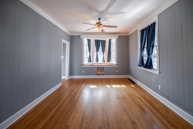 spare room with crown molding, ceiling fan, and light hardwood / wood-style floors