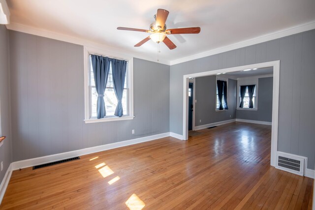 unfurnished room featuring ceiling fan, ornamental molding, and wood-type flooring