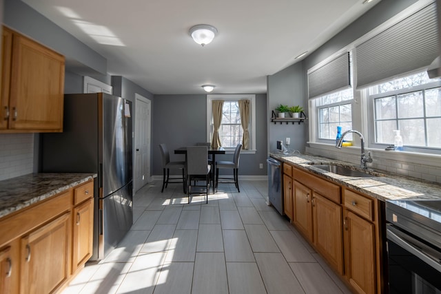 kitchen with sink, backsplash, and stainless steel appliances