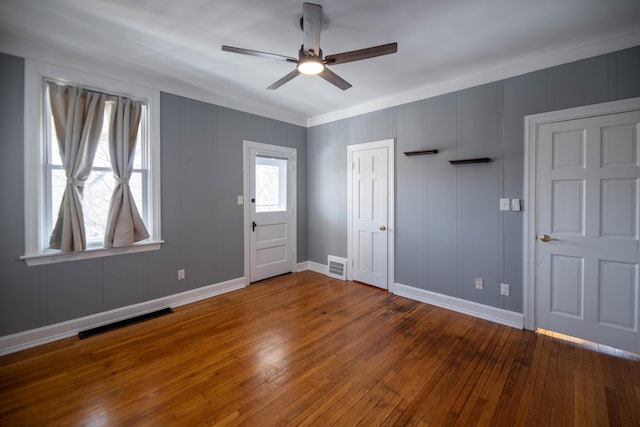 interior space featuring hardwood / wood-style flooring, ceiling fan, and crown molding