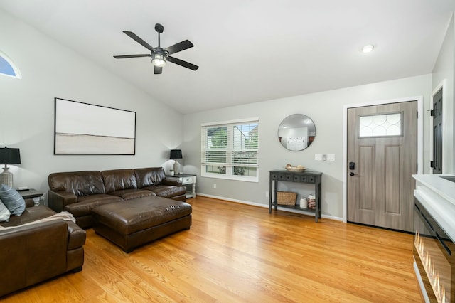 living room featuring lofted ceiling, light wood-type flooring, and ceiling fan