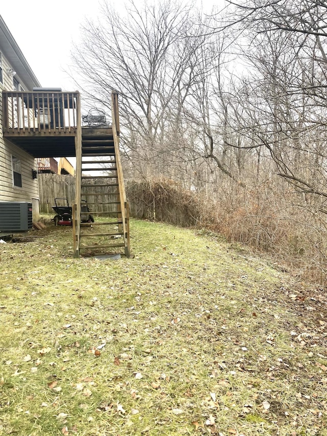 view of yard featuring central AC and a deck