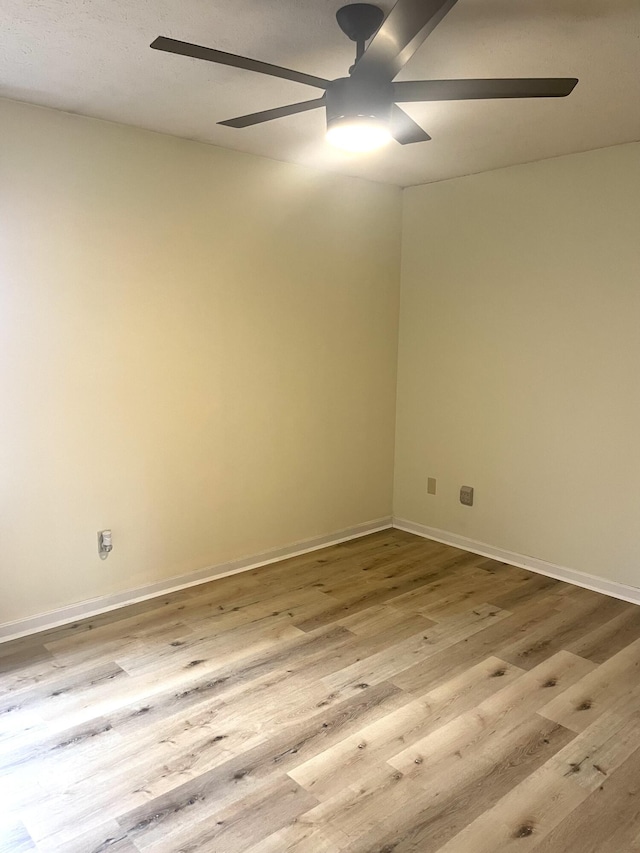 spare room featuring light hardwood / wood-style floors and ceiling fan