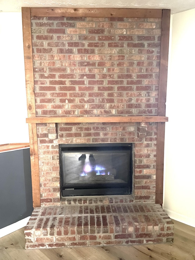 interior details featuring hardwood / wood-style flooring and a fireplace