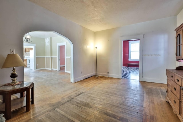 living room with a textured ceiling and light hardwood / wood-style floors