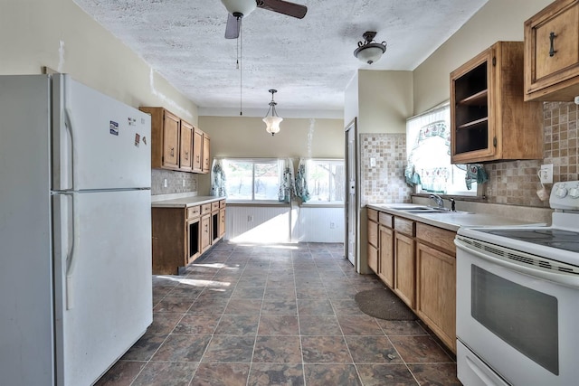 kitchen featuring white appliances, decorative light fixtures, decorative backsplash, sink, and ceiling fan