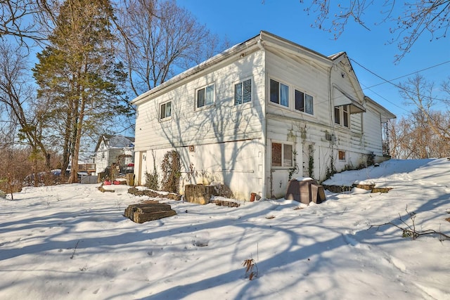 view of snow covered rear of property