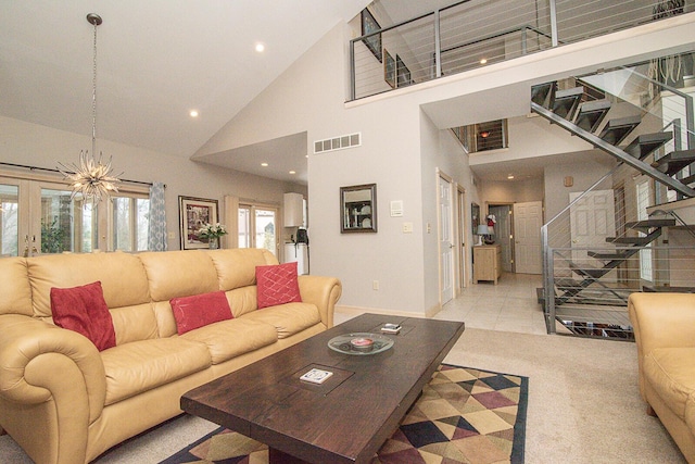 carpeted living room with a towering ceiling and french doors