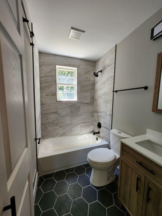 full bathroom featuring toilet, vanity, and tiled shower / bath combo