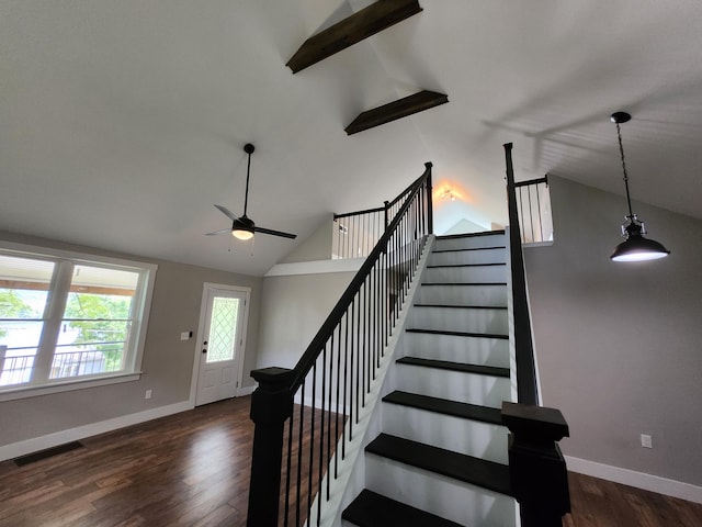 stairway with ceiling fan, lofted ceiling with beams, and wood-type flooring