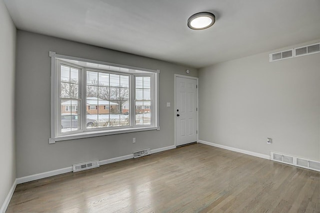 spare room featuring light hardwood / wood-style floors