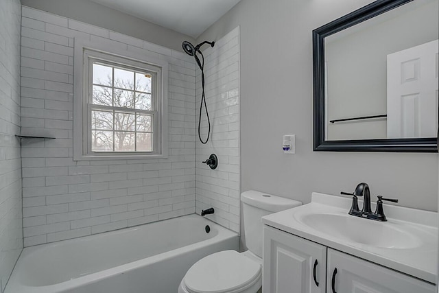 full bathroom featuring toilet, tiled shower / bath, and vanity