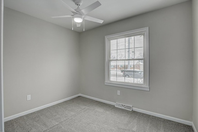 spare room featuring ceiling fan and light colored carpet