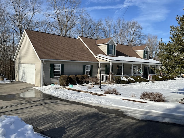 new england style home with covered porch and a garage