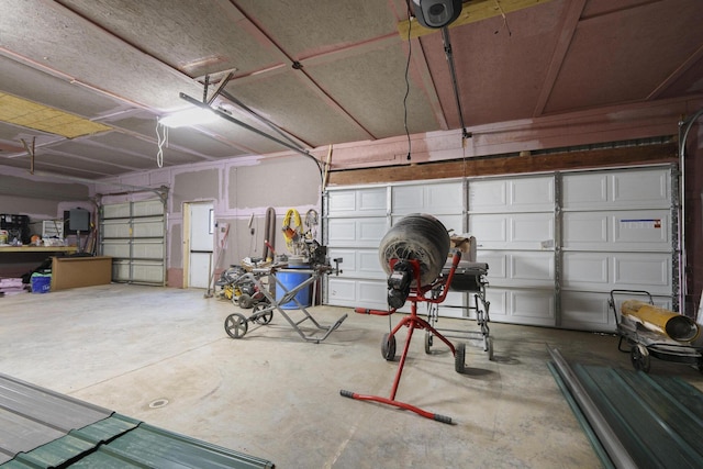 garage featuring electric panel and a garage door opener