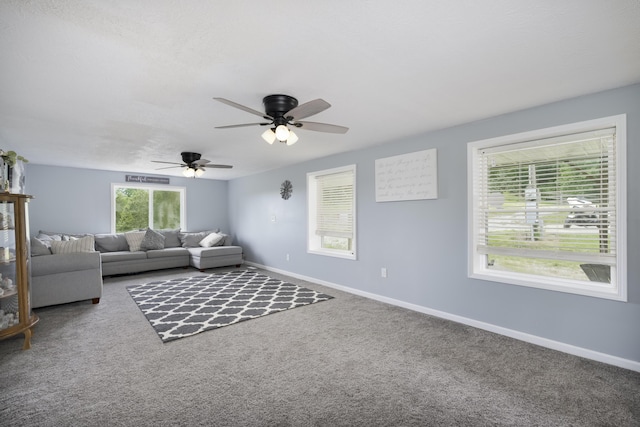 unfurnished living room with ceiling fan and carpet flooring