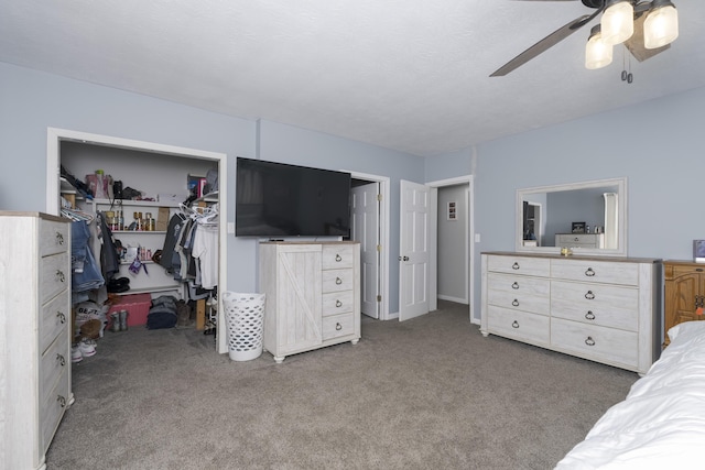 carpeted bedroom featuring ceiling fan and a closet