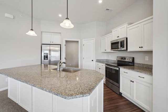 kitchen with pendant lighting, sink, a kitchen island with sink, appliances with stainless steel finishes, and white cabinets