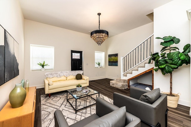 living room with hardwood / wood-style flooring and an inviting chandelier