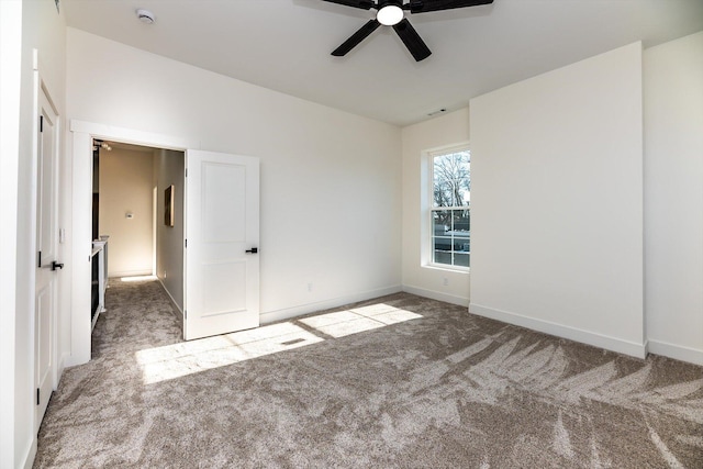 unfurnished room featuring ceiling fan and carpet floors