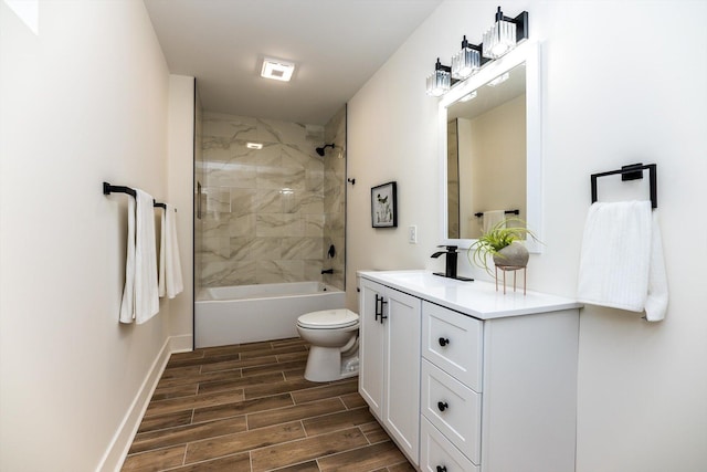 full bathroom featuring toilet, tiled shower / bath combo, and vanity