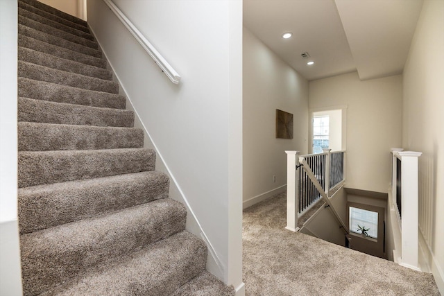 stairs featuring carpet floors