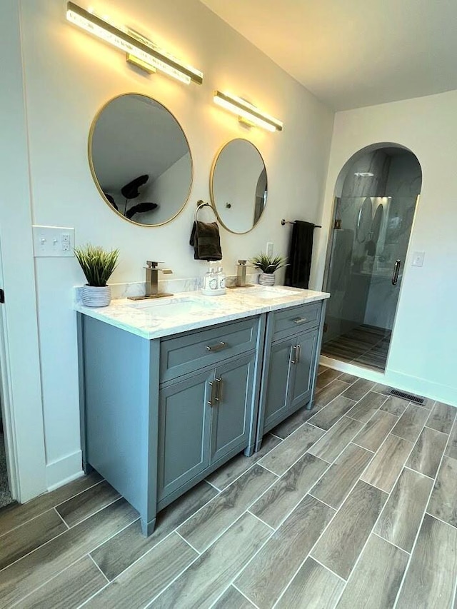 bathroom with an enclosed shower and vanity