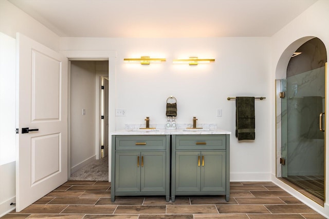 bathroom featuring an enclosed shower and vanity