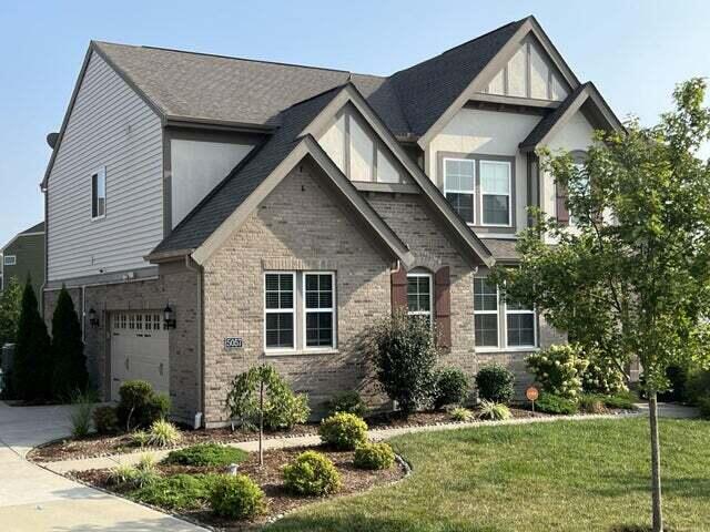 view of front of property with a front yard and a garage