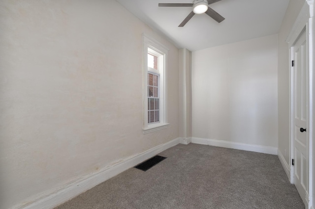 empty room with ceiling fan and carpet