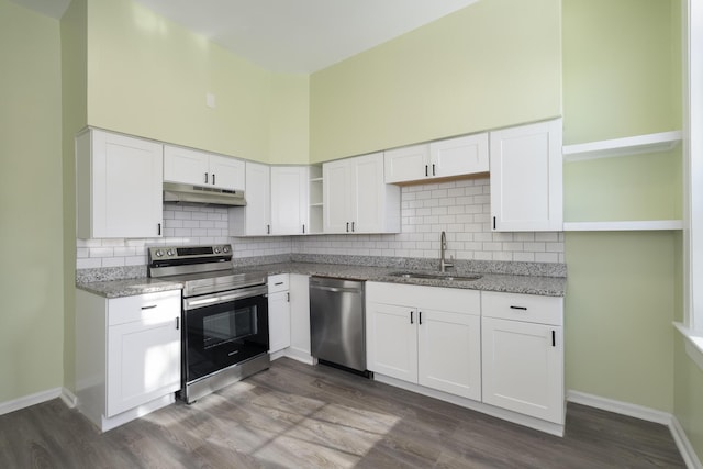 kitchen with light stone countertops, sink, white cabinets, and appliances with stainless steel finishes