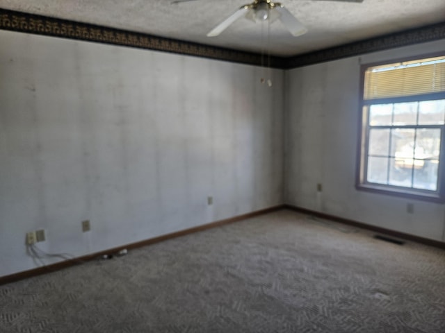 unfurnished room featuring ceiling fan, carpet, and a textured ceiling